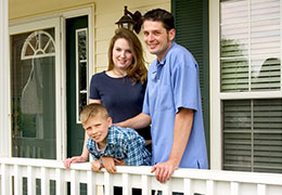 Small family on porch looking to sell their home